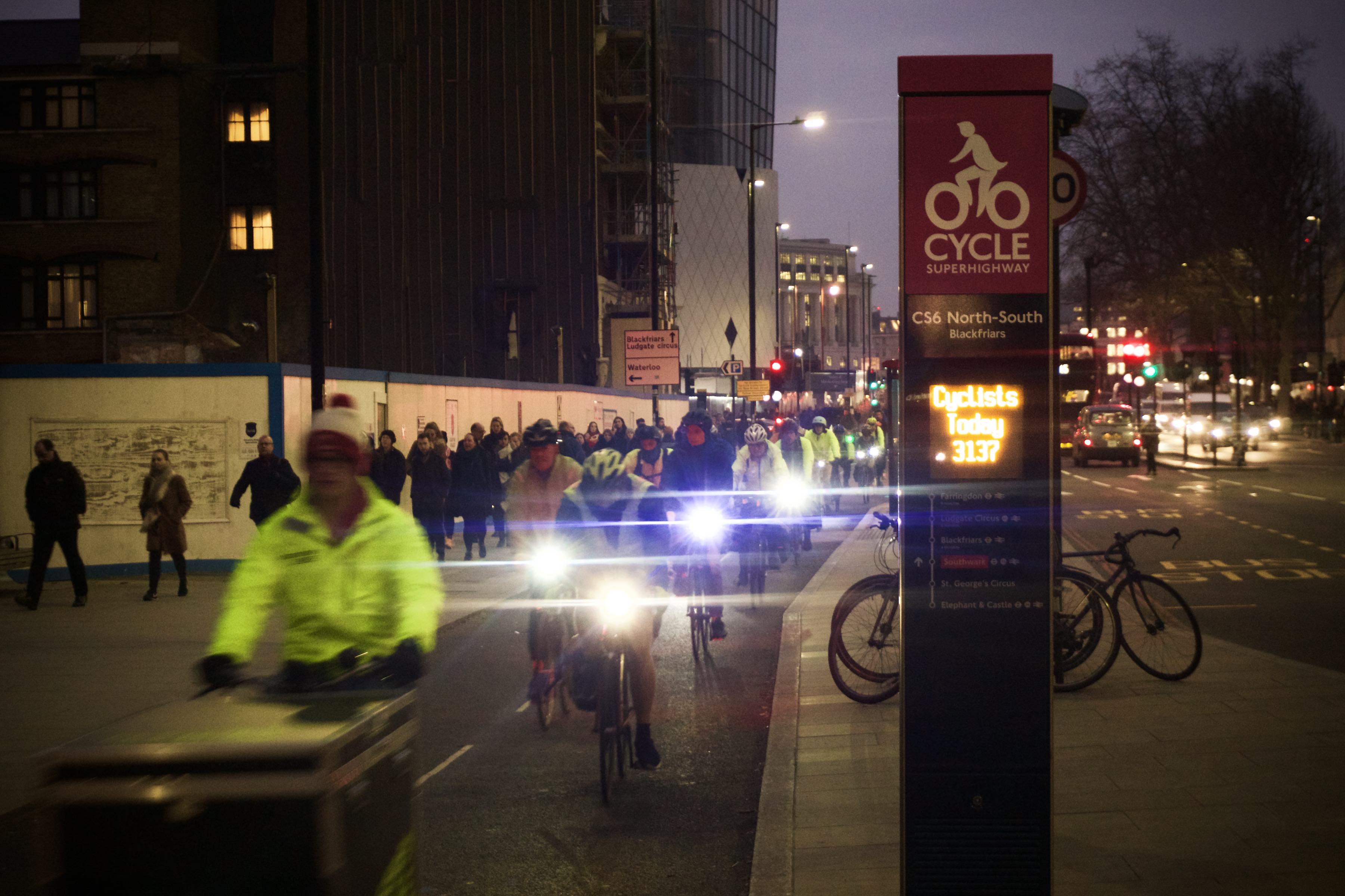 A two-way cycle track at dusk, with a cycle counter showing that 3,137 people cycled past it that day.